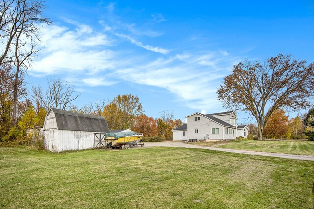 6700 Bethuy Rd, Ira, MI 48023 - view of green lawn featuring an outdoor structure and a barn