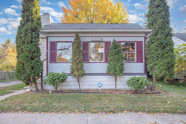 view of side of property with a yard