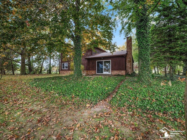 6405 Stillwater Ct, Erie, MI 48133 - rear view of property with a chimney and brick siding