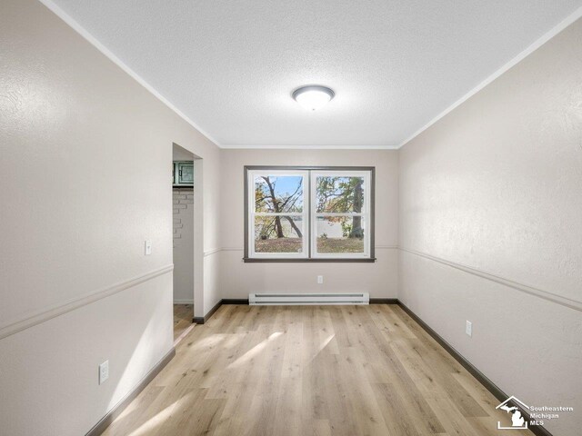 6405 Stillwater Ct, Erie, MI 48133 - spare room with light wood-type flooring, baseboard heating, crown molding, a textured ceiling, and baseboards