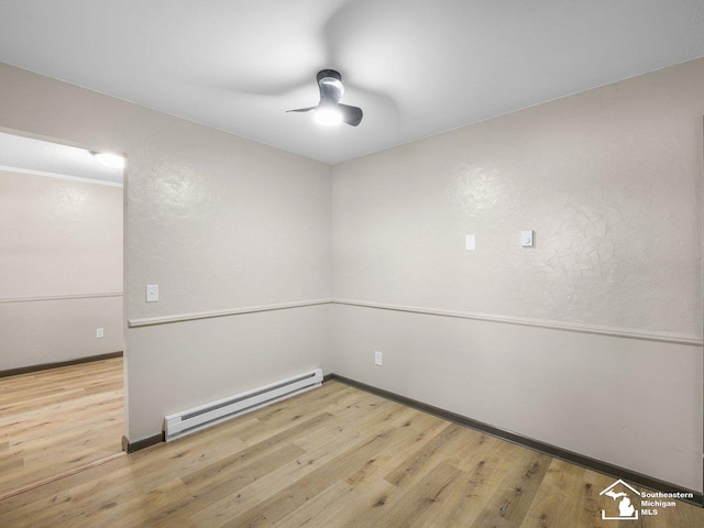 6405 Stillwater Ct, Erie, MI 48133 - empty room featuring baseboard heating, wood finished floors, ceiling fan, and baseboards