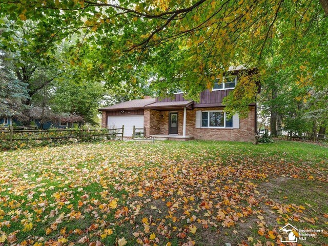 6405 Stillwater Ct, Erie, MI 48133 - view of front of home featuring a garage, board and batten siding, and brick siding