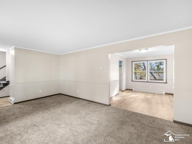 6405 Stillwater Ct, Erie, MI 48133 - unfurnished living room with carpet floors, a baseboard heating unit, crown molding, baseboards, and stairs