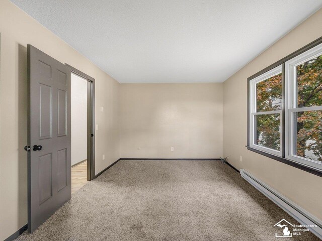 6405 Stillwater Ct, Erie, MI 48133 - unfurnished bedroom with light colored carpet, baseboard heating, and baseboards