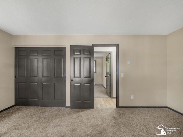 6405 Stillwater Ct, Erie, MI 48133 - unfurnished bedroom with light carpet, baseboards, and a closet