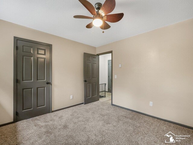 6405 Stillwater Ct, Erie, MI 48133 - unfurnished bedroom featuring light colored carpet, baseboards, and ceiling fan