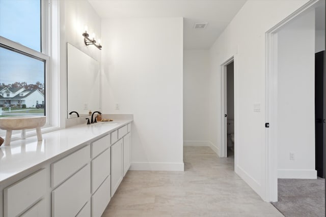 bathroom featuring vanity and toilet