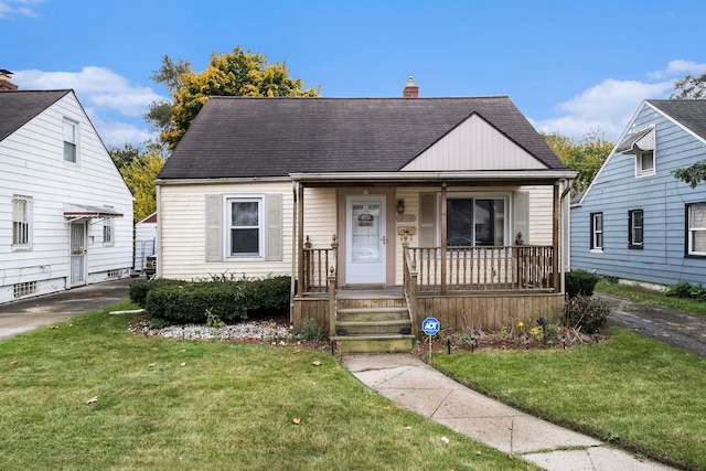 bungalow featuring a front lawn and a porch