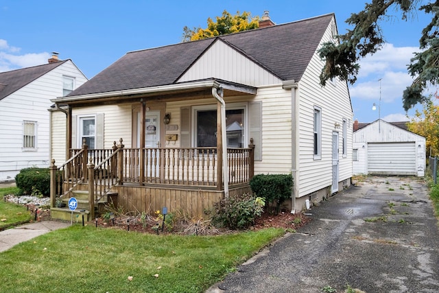 bungalow-style house featuring an outbuilding, a front yard, and a garage