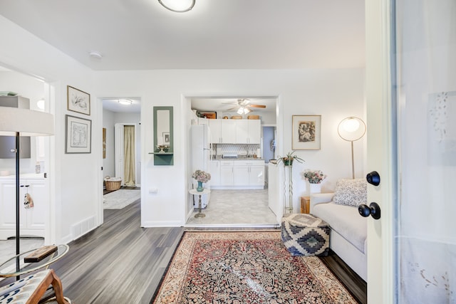 living room featuring hardwood / wood-style floors and ceiling fan