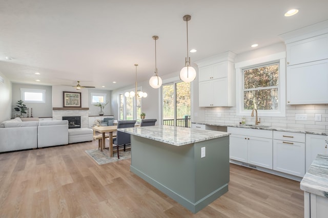 2680 Ashford Trl, Portage, MI 49024 - kitchen featuring a sink, a ceiling fan, a center island, white cabinets, and recessed lighting