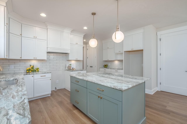 2680 Ashford Trl, Portage, MI 49024 - kitchen featuring light wood-type flooring, white cabinets, backsplash, light stone countertops, and recessed lighting