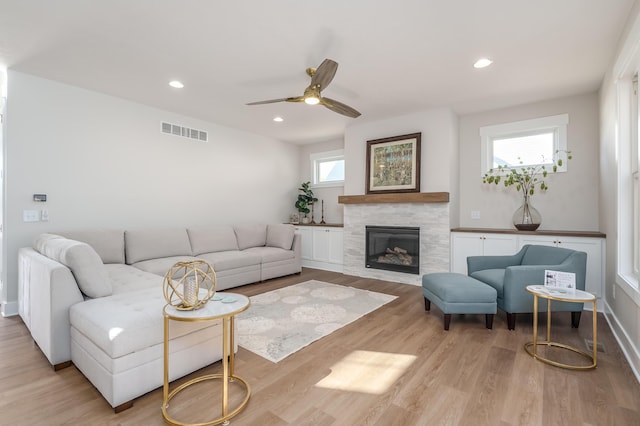 2680 Ashford Trl, Portage, MI 49024 - living room with a ceiling fan, wood finished floors, a tiled fireplace, recessed lighting, and baseboards