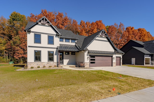 2680 Ashford Trl, Portage, MI 49024 - view of front facade with a standing seam roof, stone siding, metal roof, a garage, and a front lawn