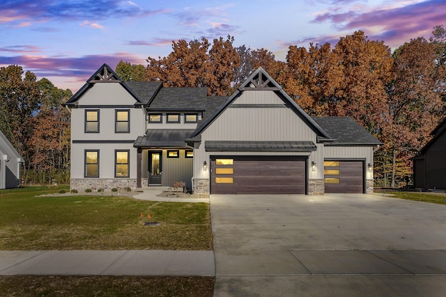 2680 Ashford Trl, Portage, MI 49024 - modern farmhouse style home featuring a standing seam roof, stone siding, a garage, and a lawn