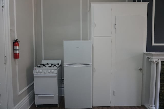 kitchen featuring wood-type flooring and white appliances