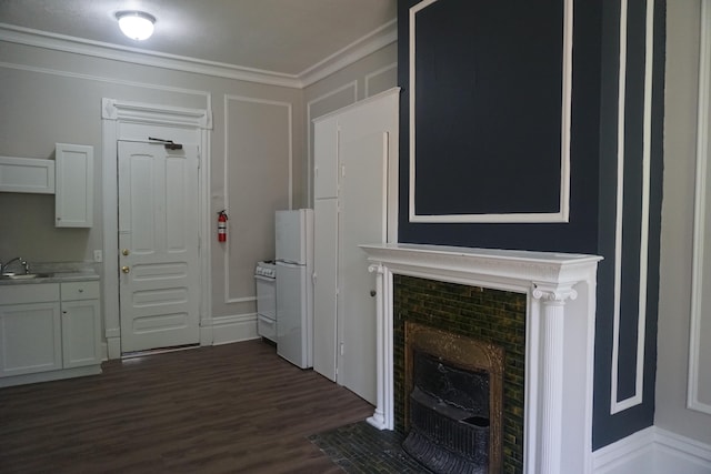 unfurnished living room with dark wood-type flooring, sink, and crown molding