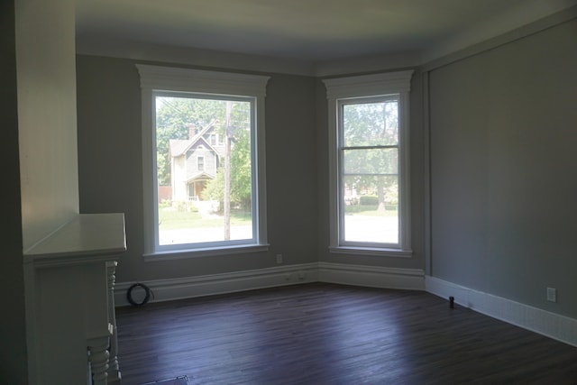 unfurnished room with dark hardwood / wood-style floors