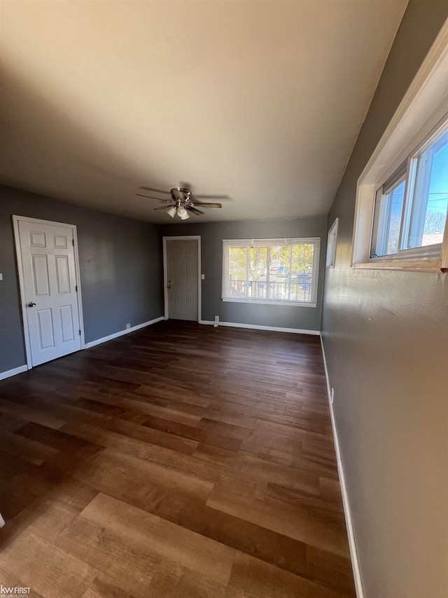 interior space featuring ceiling fan and dark hardwood / wood-style floors