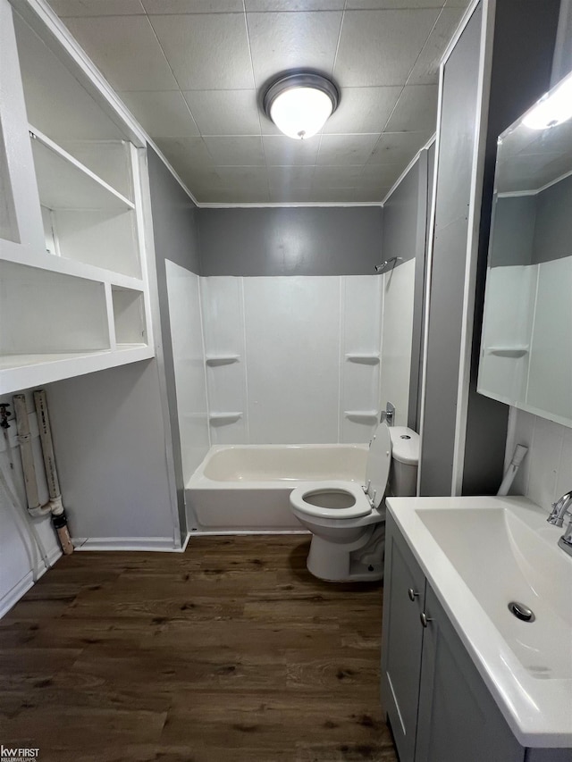 full bathroom with vanity, toilet, wood-type flooring, and shower / washtub combination