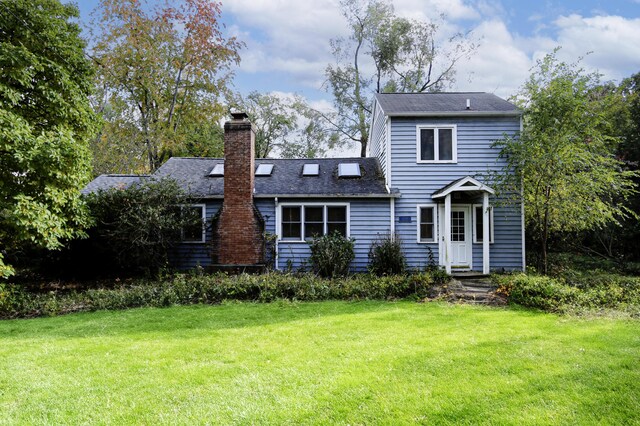 17388 Arbor Ln, New Buffalo, MI 49117 - rear view of property featuring a chimney and a yard