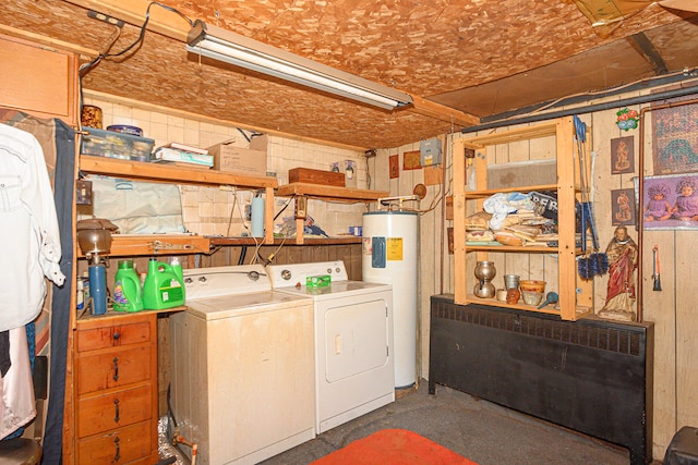 laundry room featuring washing machine and clothes dryer and water heater