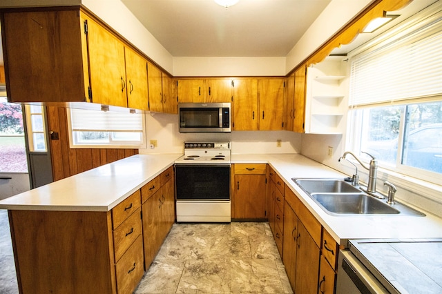 kitchen with dishwasher, sink, plenty of natural light, and electric stove