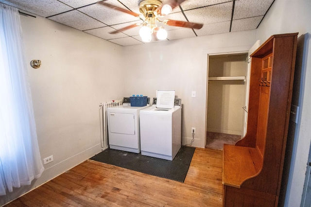 washroom featuring ceiling fan, hardwood / wood-style floors, and washer and dryer