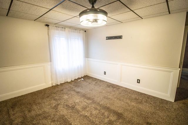 unfurnished room with carpet and a paneled ceiling