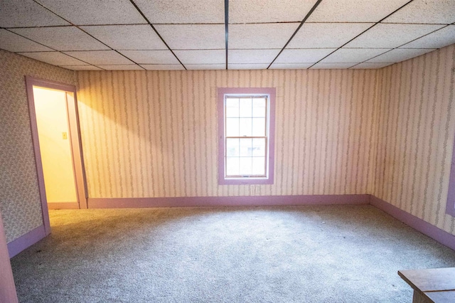 unfurnished room with a drop ceiling and carpet floors