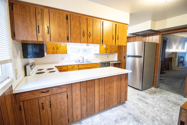 kitchen with kitchen peninsula, sink, and appliances with stainless steel finishes