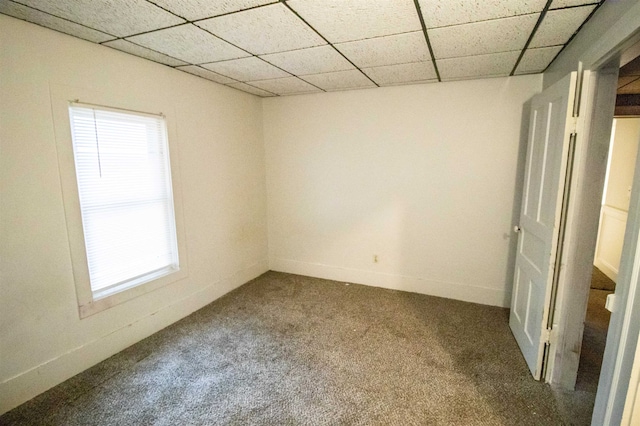 carpeted spare room with a paneled ceiling