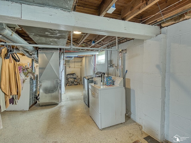 basement with washer and dryer and heating unit