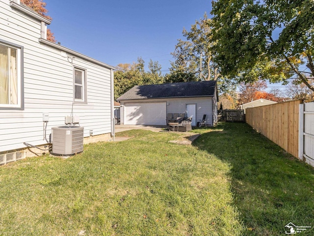 view of yard with an outbuilding, cooling unit, and a garage