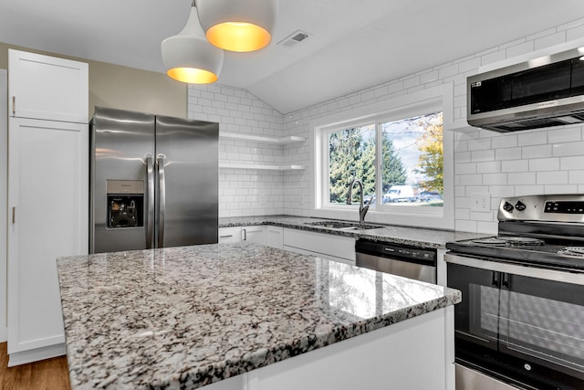 kitchen with a center island, dark hardwood / wood-style flooring, stainless steel appliances, and white cabinetry