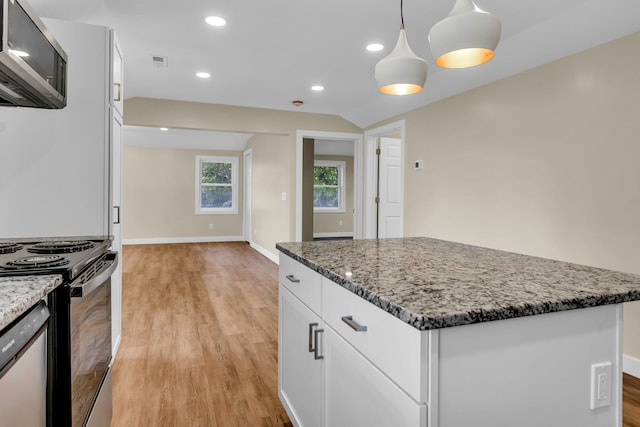 kitchen with white cabinets, appliances with stainless steel finishes, decorative light fixtures, light hardwood / wood-style floors, and light stone counters