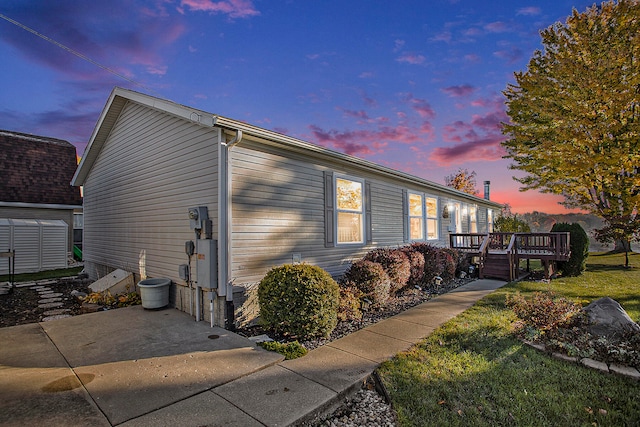 property exterior at dusk with a deck