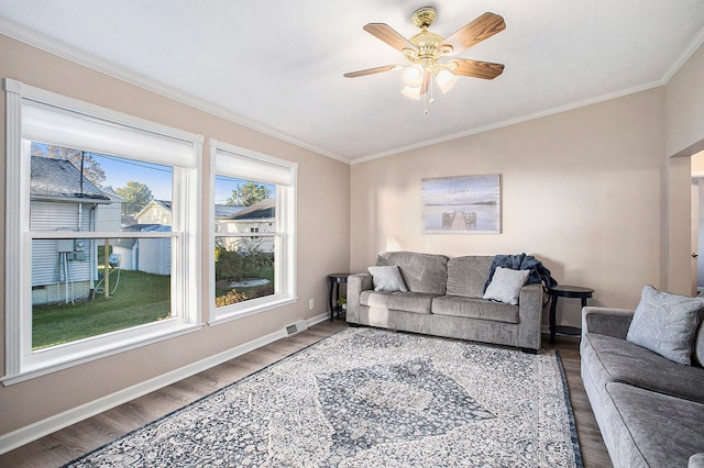 living room with hardwood / wood-style floors, ceiling fan, lofted ceiling, and crown molding