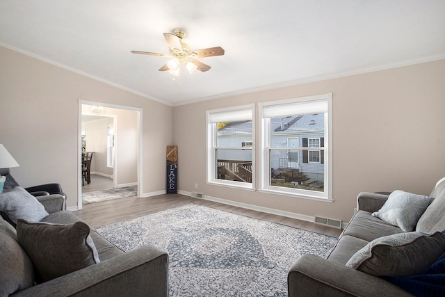 living room with crown molding, light hardwood / wood-style flooring, ceiling fan, and vaulted ceiling