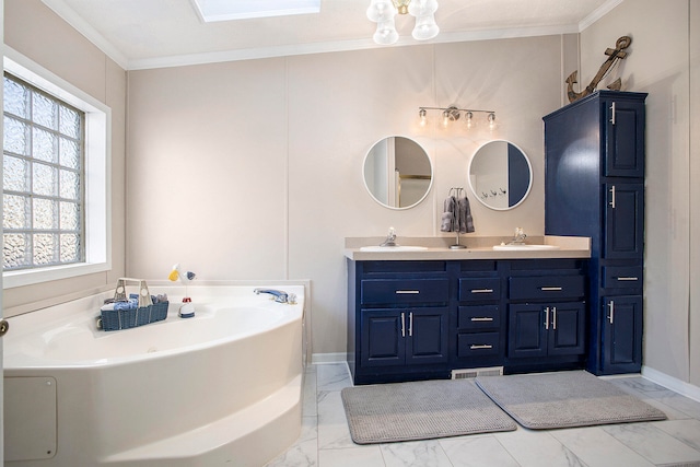 bathroom with vanity, ornamental molding, and a tub