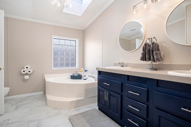 bathroom featuring a skylight, a bathtub, ornamental molding, vanity, and toilet