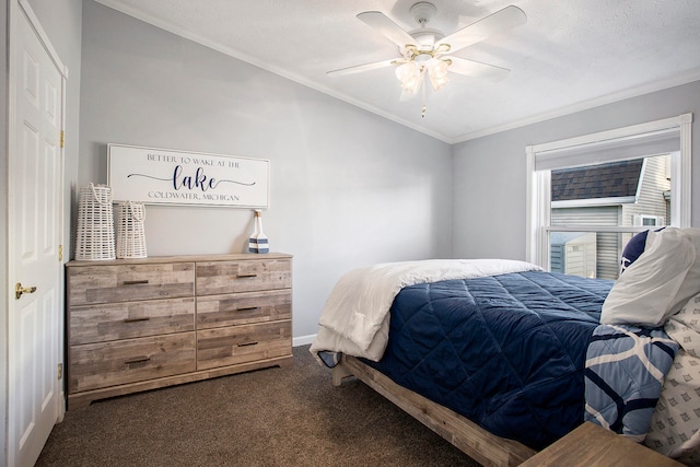 carpeted bedroom featuring ceiling fan, a textured ceiling, and ornamental molding