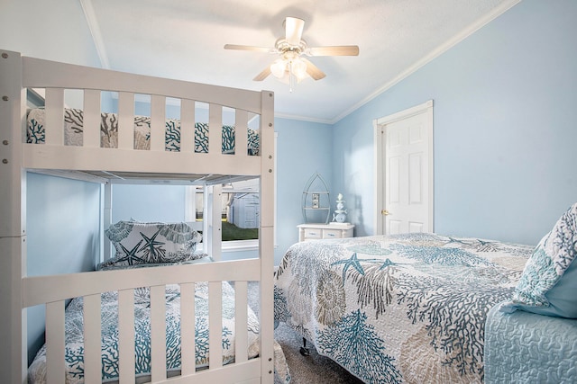 carpeted bedroom featuring ceiling fan and crown molding