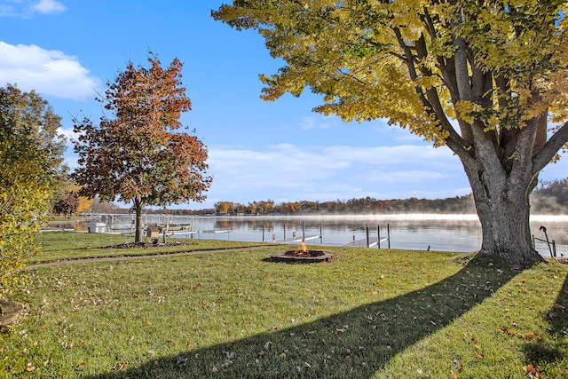 view of yard with a water view and an outdoor fire pit