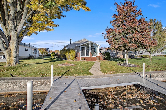 view of dock featuring a lawn