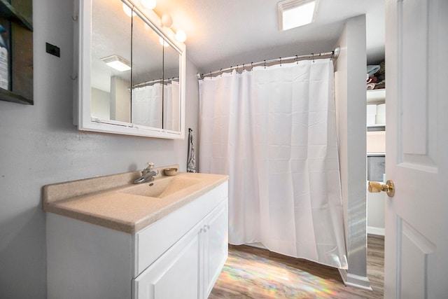 bathroom featuring hardwood / wood-style floors and vanity