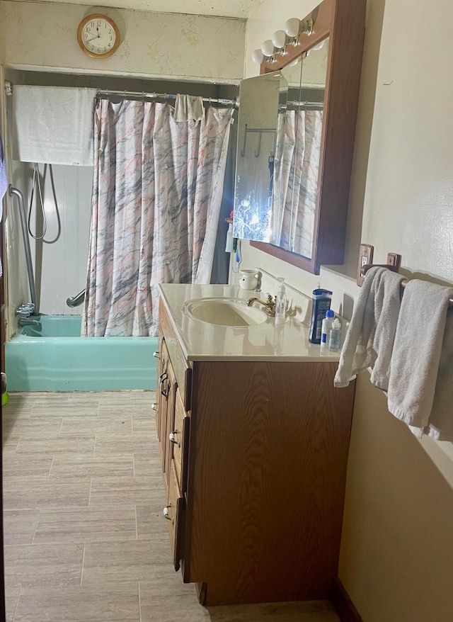 bathroom with shower / tub combo with curtain and vanity