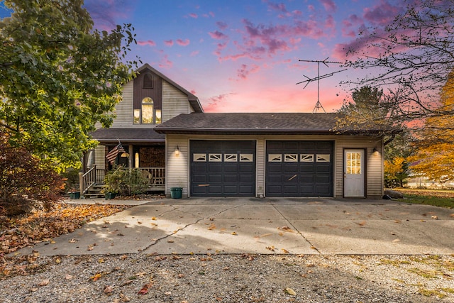 view of property with a porch and a garage