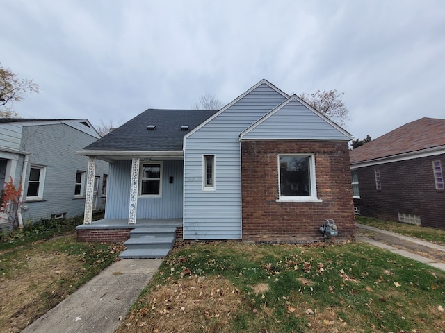 bungalow-style house with covered porch and a front yard