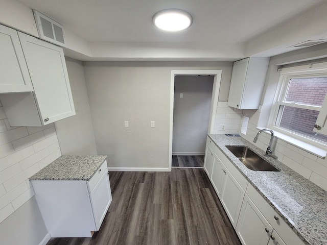 kitchen featuring white cabinetry, sink, dark wood-type flooring, and light stone counters